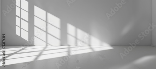 Abstract white background with shadows from window and light rays on the floor for product presentation.
