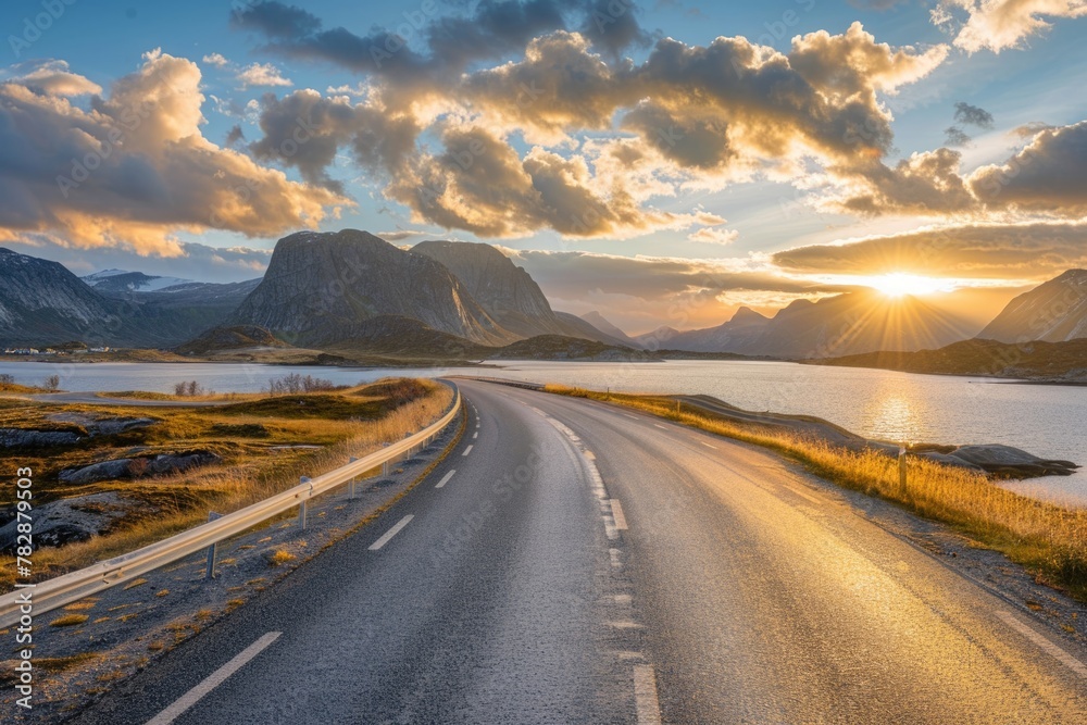 Beautiful road at sunset with a dramatic sky and mountains in the background.