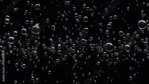 Closeup - rain water drops behind glass look like bubbles in black liquid. Abstract wet background.