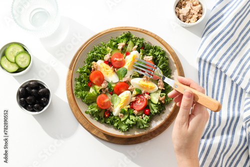 Ready salad with tuna on a wooden board. photo