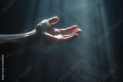 Hand in the dark hand reaches for the ray of light. Hope, loneliness, faith, depression concept