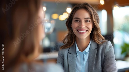 A congenial Asian HR Manager, impeccably dressed in a suit, beams warmly, fostering a welcoming ambiance, pivotal for a successful job interview.
