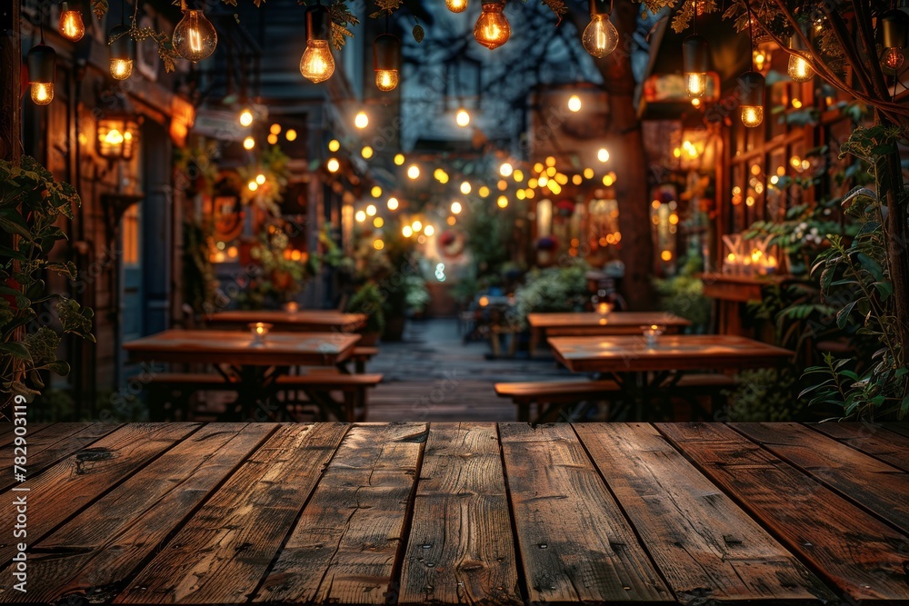 Nighttime scene capturing the glow of string lights over wooden tables, plants, and elegant decorations