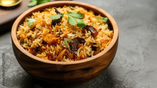 Freshly cooked delicious veg biryani (rice dish) and various toppings in bowl, inviting the viewer to enjoy a serving of this delectable dish.