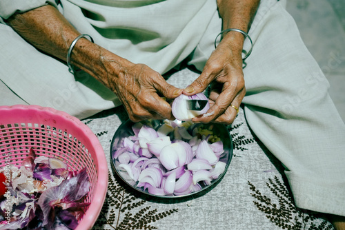 Old Indian women cutting onion (pyaaz) photo