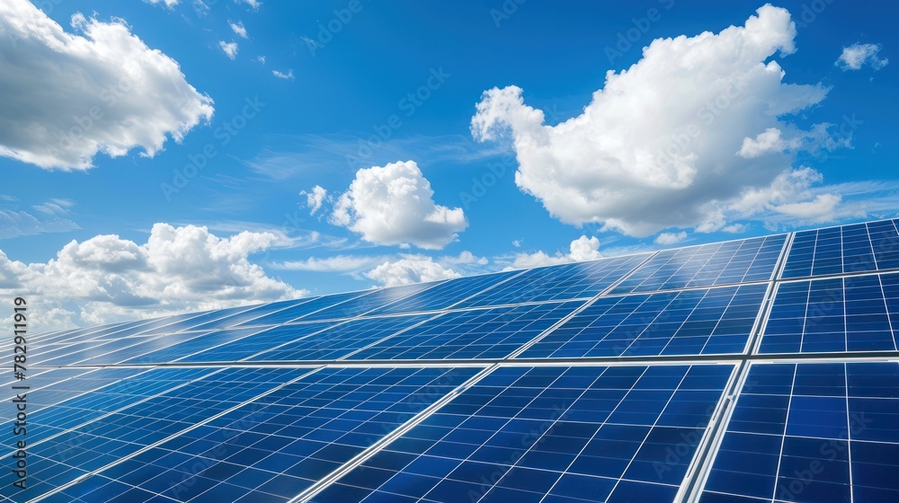 Solar panels against a bright animated cloud sky background. 