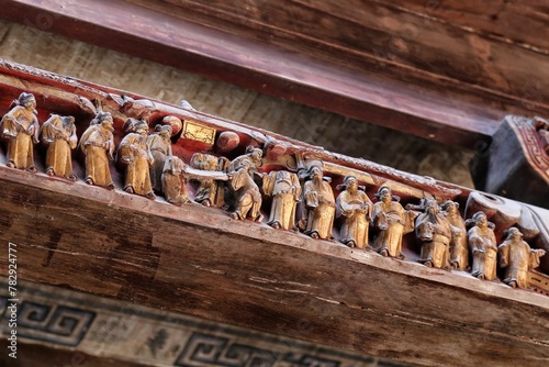 Closeup of the wood engravings of people on a building