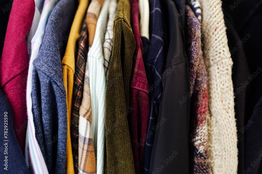 Group of clothes on hangers in the cream closet