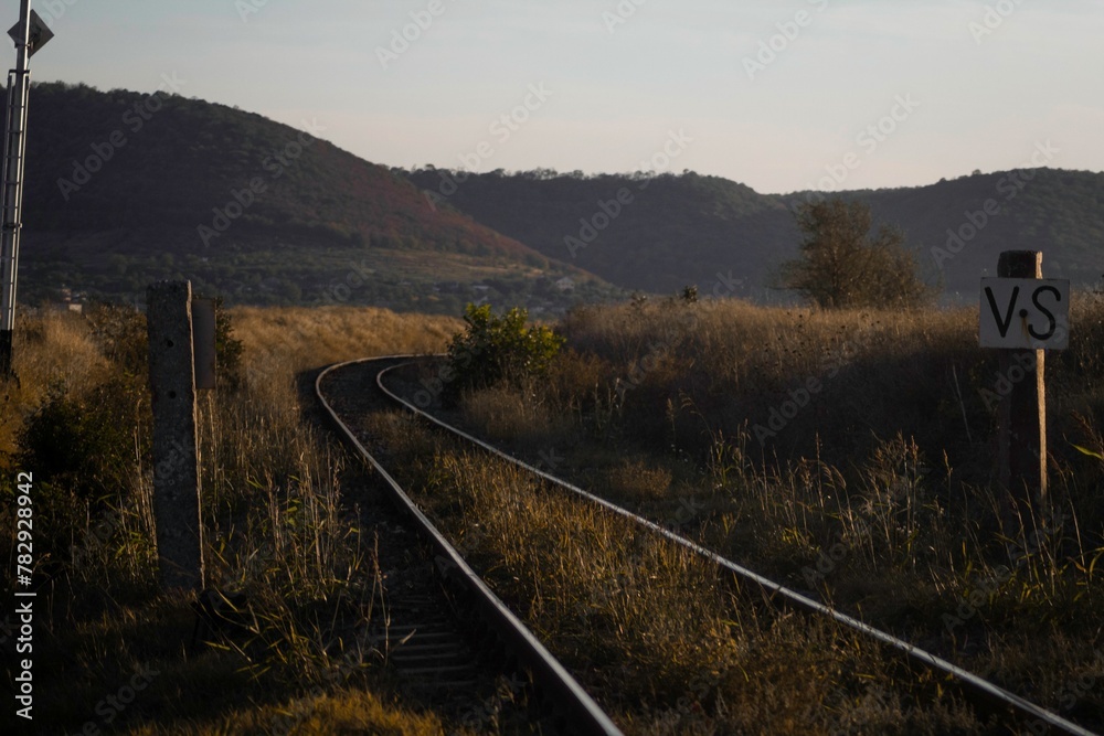 High-angle of an abandoned railway station with yellow grass growing around, clear sky background High-angle of an abandoned railway station with yellow grass growing around, clear sky background