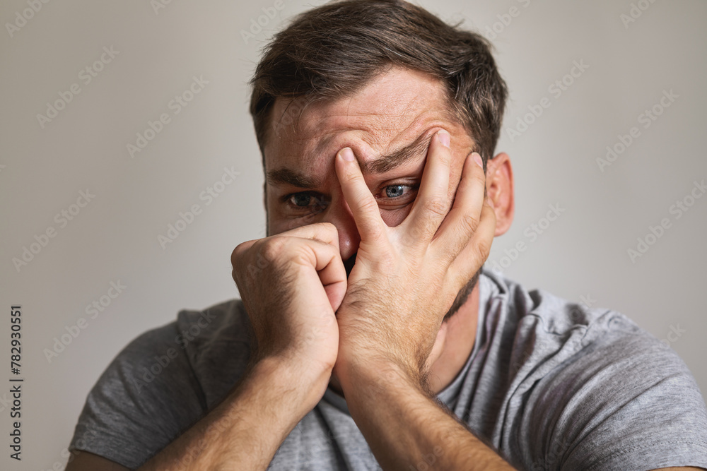 Male mental illness concept. Close-up of a man's face with an expression of despair. Male mental illness concept. Close-up of a man's face with an expression of despair.