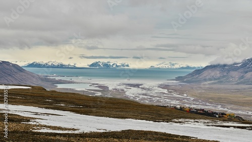 Mountain lake at a distance on cloudy sky background in Spitsbergen, Norway