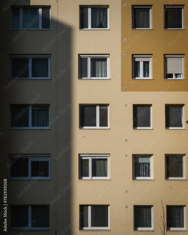 Vertical shot of the exterior of a beige residential building
