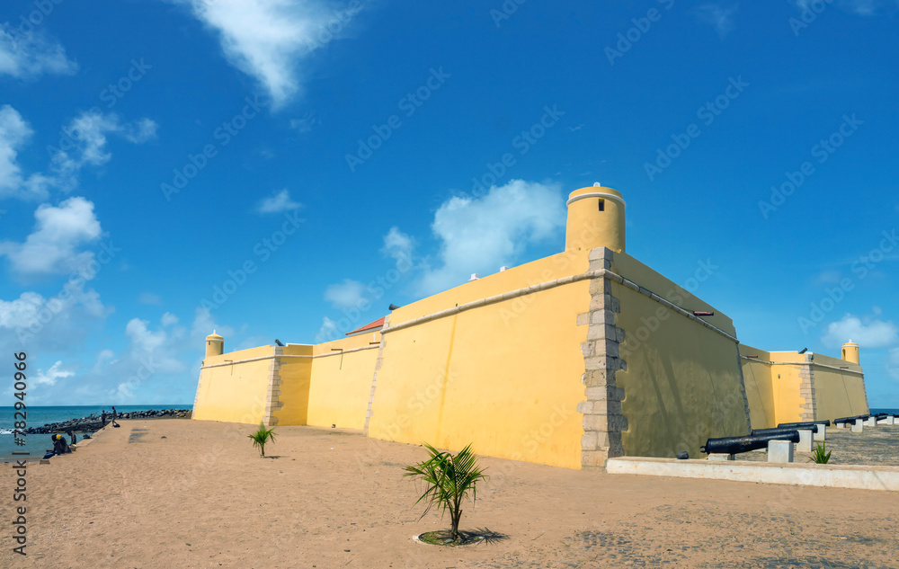 Fototapeta premium Beach in Ana Chaves Bay in São Tomé, with the XVI century historical São Sebastião fort, São Tomé and Principe (STP), Central Africa