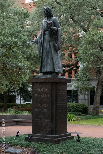 Vertical shot of the historic John Wesley Statue in Reynolds Square, Savannah, Georgia photo
