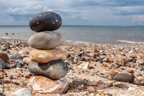 A tower built of pebbles on a beach photo
