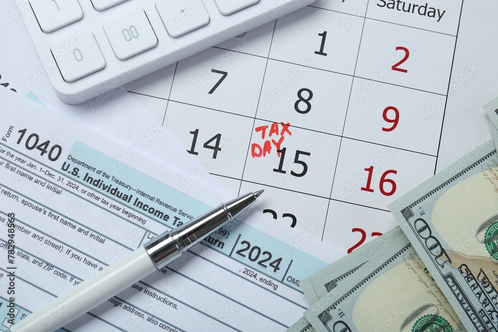 Calendar with date reminder about tax day, documents, pen, calculator and money, top view Calendar with date reminder about tax day, documents, pen, calculator and money, top view