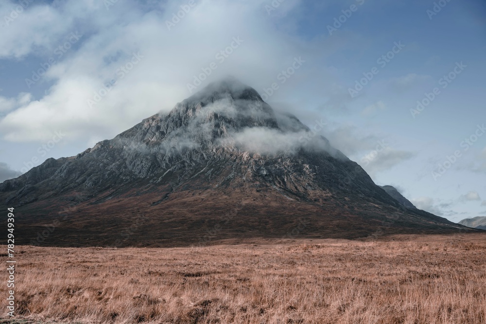 Fototapeta premium Beautiful view of the Buachaille Etive Mor covered in clouds in Glencoe