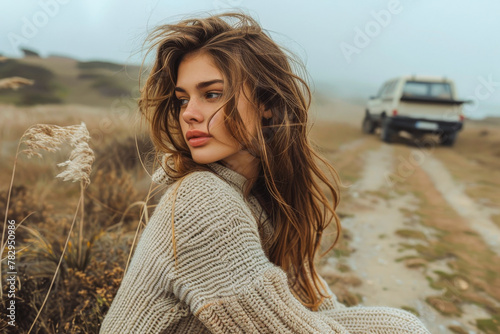 Serene Woman in Cozy Sweater Enjoying Misty Coastal Landscape photo