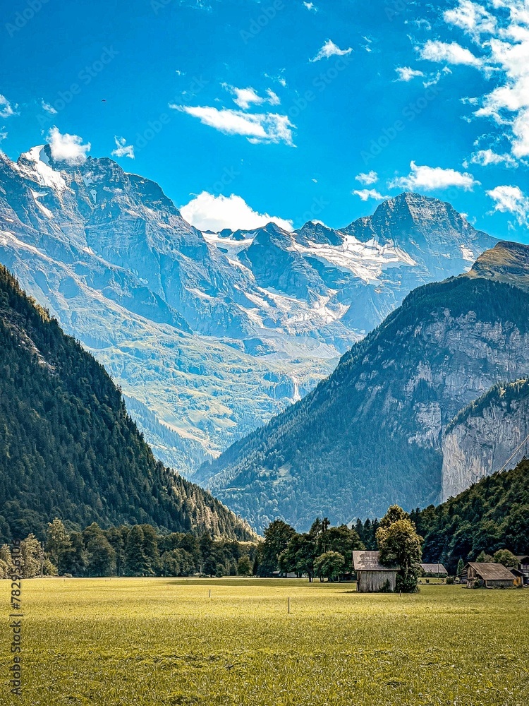 Vertical shot of the rocky mountains under a bright sky in Lauterbrunnen, Switzerland