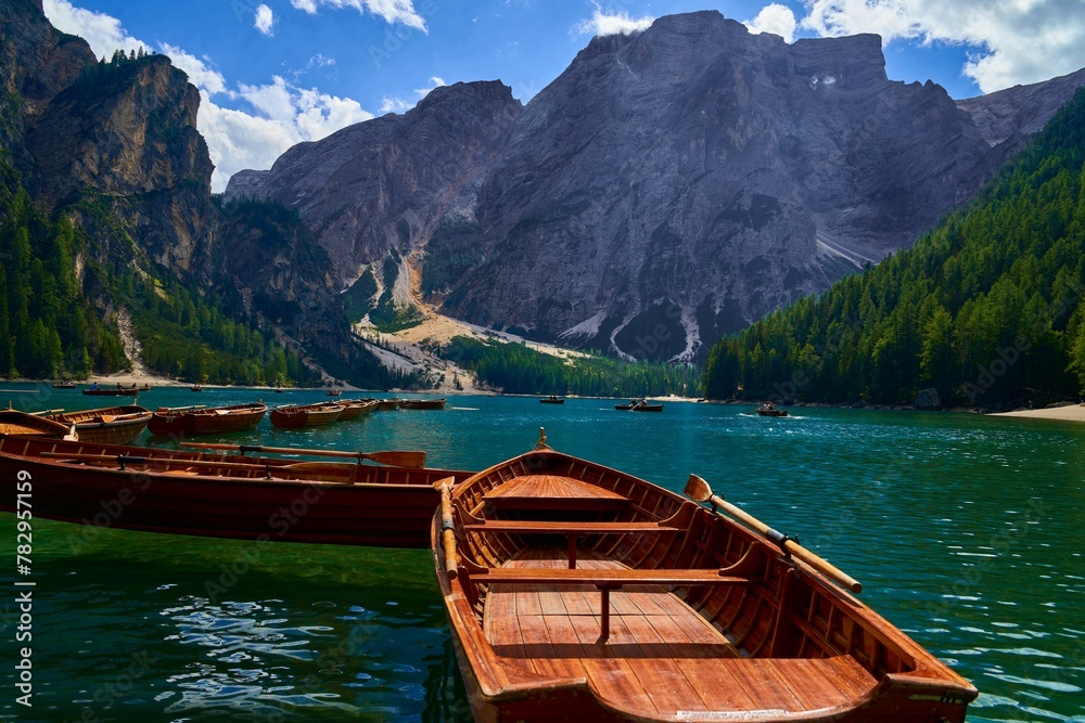 Drone shot of wooden boats on the surface of Lake Braies in Italy