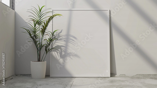 A mockup of an empty blank white poster frame laying on the floor