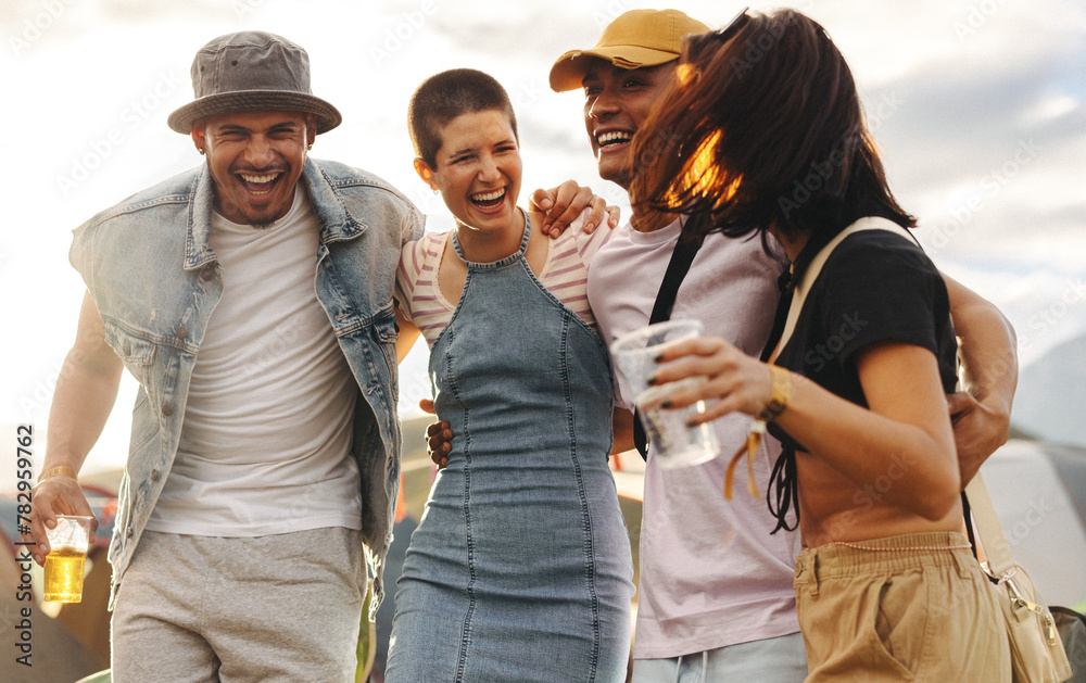 © Jacob Lund - Young people celebrating summer with drinks amid festival vibes