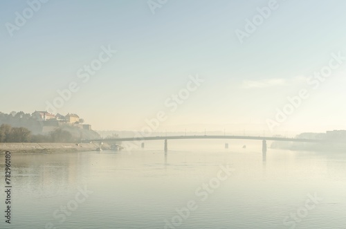 Distant view of the Varadin Bridge and the Danube River covered with autumn fog, Serbia