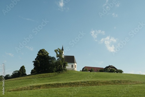 Old church on the hill in Seekirchen against a blue sky