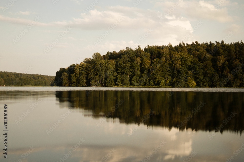 Clear lake with the trees reflection on the water Clear lake with the trees reflection on the water