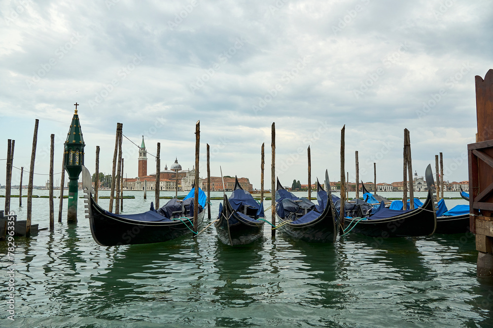 Empty docked gondolas against the Church of San Giorgio Maggiore in the background in Venice, Italy
