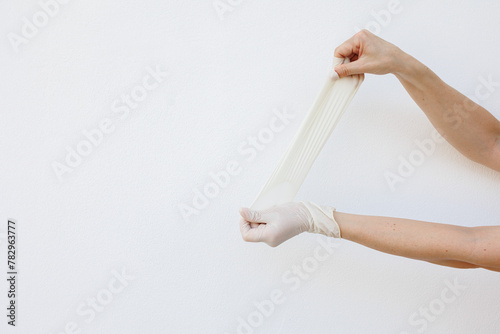 Female hands wearing disposable gloves photo