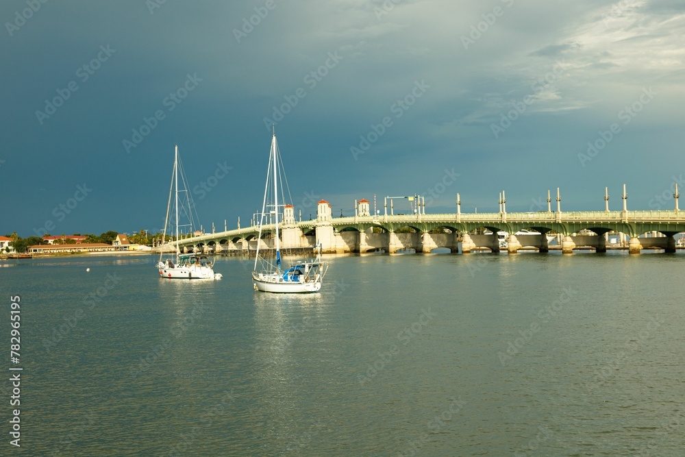 Fototapeta premium Historical St Augustine Bridge with sailboats on the sea