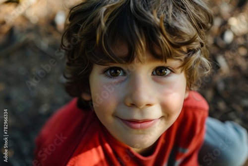 Portrait of a little boy with brown eyes in the park.