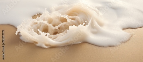 Wave foams over sandy shore