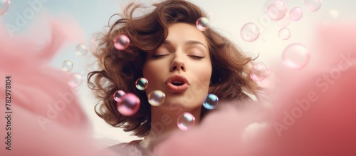 Woman blows bubbles, plays with bubble gum photo