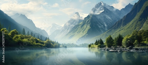 Mountains and trees reflect in lake water photo