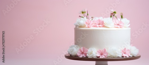 Pink flower adorned white cake