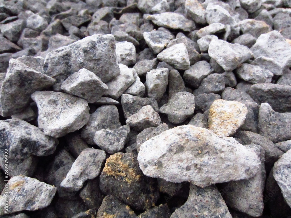 Large pieces of gray rubble or gravel are prepared for work.