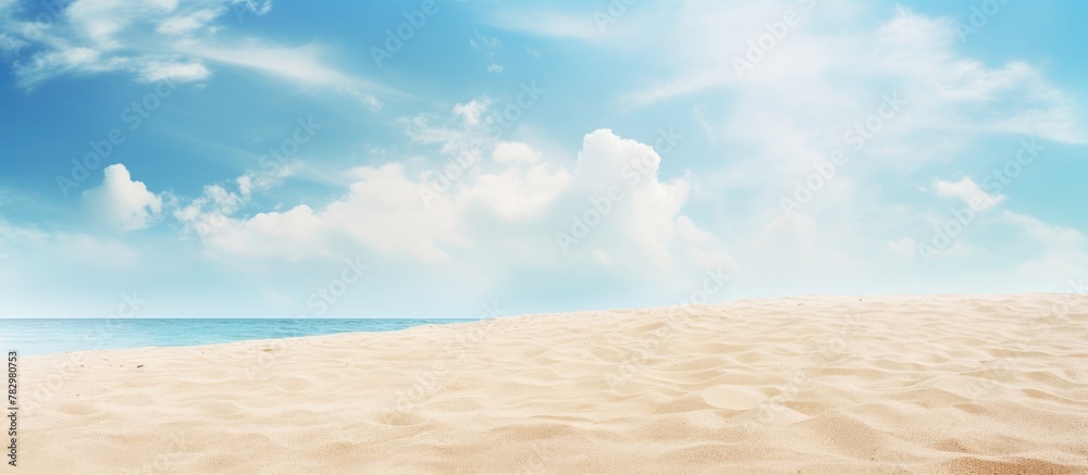 Fototapeta premium Sandy beach with blue sky and clouds