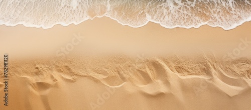 Wave approaching sandy beach photo