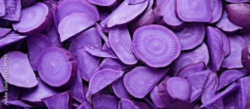 Purple potatoes piled on table