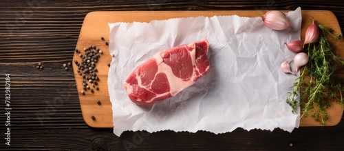 Raw meat and garlic on cutt...