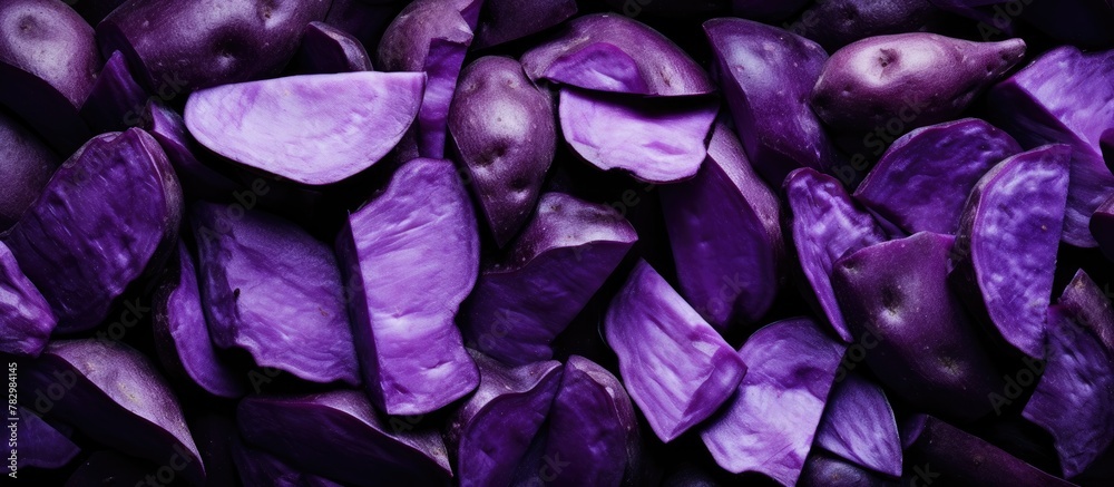 Purple potatoes piled on table