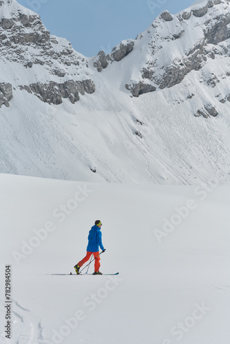 A Skier Scales a Treacherous Alpine Peak