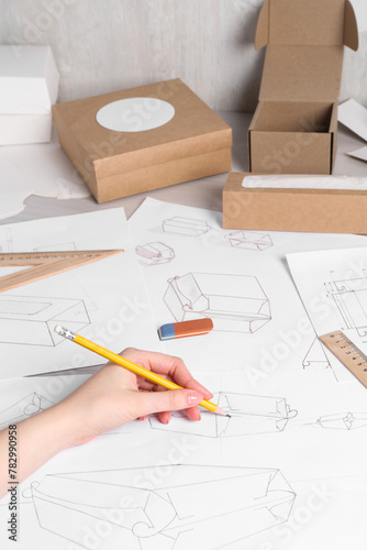 Woman creating packaging design at table, closeup