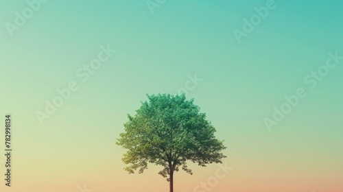 Tree stands alone  vibrant green  with Earth Day themed gradient background. A green tree is the centerpiece for Earth Day  with a sky to ground color fade.