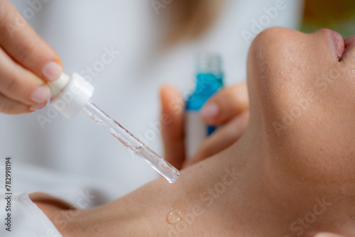 Cosmetician applies hyaluronic acid serum on woman s neck for targeted anti-aging benefits  enhancing skin elasticity and firmness