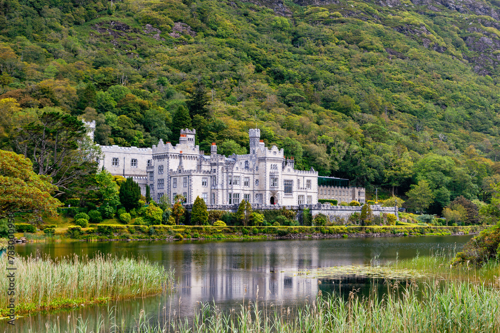 Kylemore Abbey with water reflections in Connemara, County Galway, Ireland, Europe. Benedictine monastery founded 1920 on the grounds of Kylemore Castle. Mainistir na Coille Moire Kylemore Abbey with water reflections in Connemara, County Galway, Ireland, Europe. Benedictine monastery founded 1920 on the grounds of Kylemore Castle. Mainistir na Coille Moire