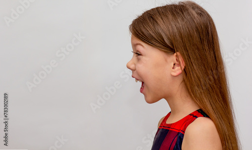 Profile of child with open mouth on white background