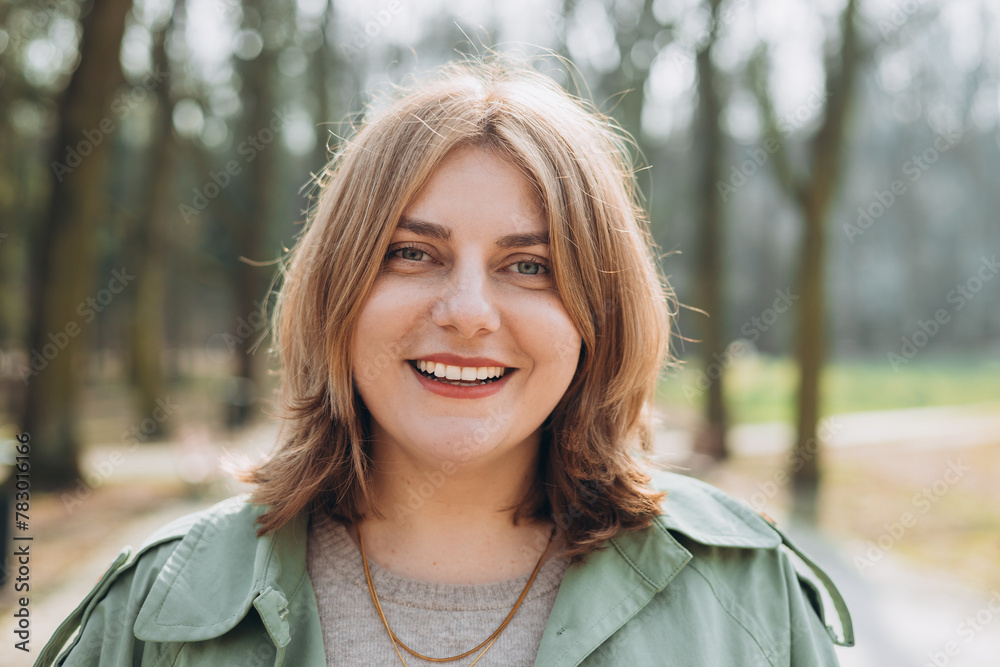 Outdoors portrait of beautiful young woman laughing. 30s cheerful woman tourist dressed in casual look resting outdoors. Urban, people concept. High quality photo